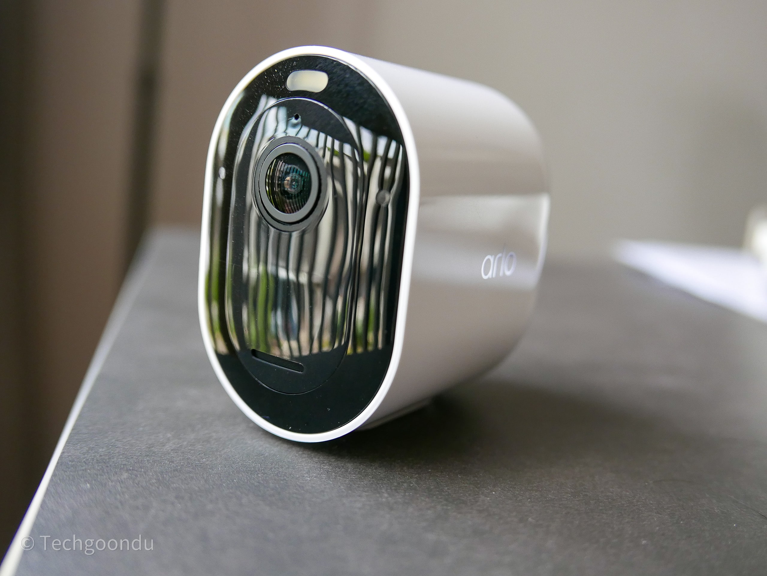 Arlo Pro 5 AI security camera, a sleek white outdoor camera, highlighted as the best for advanced AI vehicle detection and classification, including license plates.
