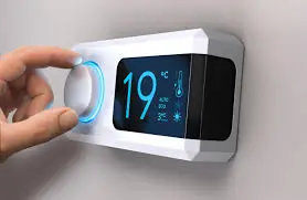 For accessibility, consider: "Smart thermostat device showing 19 degrees on digital display