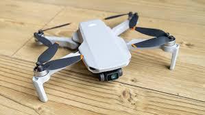 DJI Mini 4K drone on wooden surface showing compact white design and affordable budget-friendly option