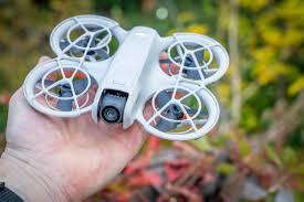 DJI Neo selfie drone being held in palm of hand showing compact size and portability
