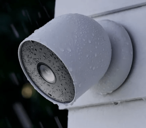 Google Nest Cam (Battery) outdoor security camera with droplets, showcasing its weather-resistant design and seamless integration as the best smart home security camera for 2025.
