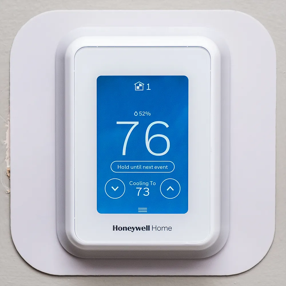 Honeywell T9 Smart Thermostat displayed on a webpage with a blue screen showing the temperature as 76 degrees Fahrenheit.
