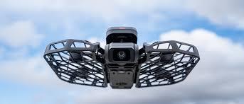 HoverAir X1 Pro drone flying against blue sky with protective cage design ideal for travel vloggers