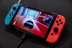 A Nintendo Switch 2 console with red and blue Joy-Con controllers displayed on a screen.