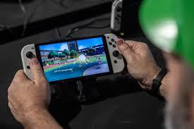 Person holding Nintendo Switch 2 showcasing vivid 1080p LCD screen with HDR and 120fps support
