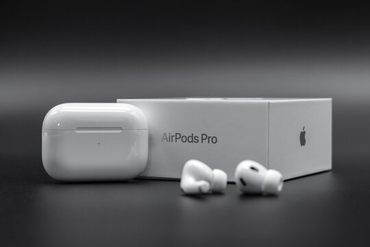 White Apple AirPods Pro 2 wireless earbuds with charging case next to their original retail box, for a comprehensive 2025 review.