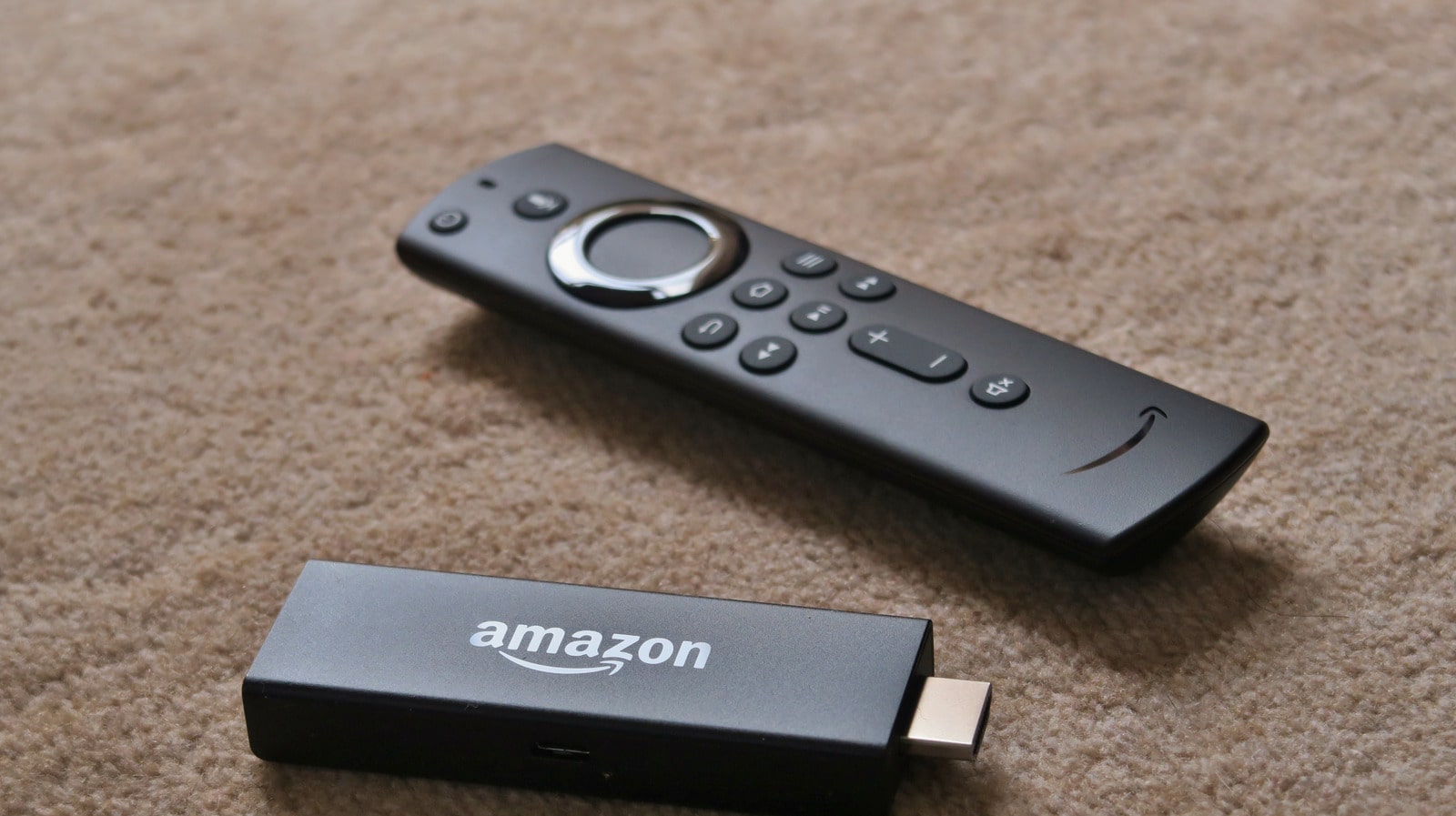 Amazon Fire TV Stick device and voice remote, symbolizing the best Fire TV Stick models for 2025, reviewed for top streaming performance.