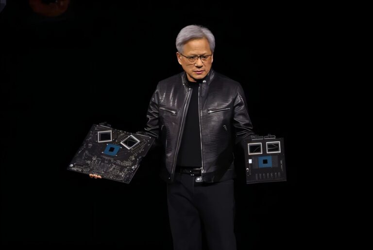 NVIDIA CEO presenting the NVIDIA Hopper H100 GPU at a tech event.
