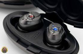 Close-up view of wireless earbuds in their charging case, highlighting their sleek design and compact size.